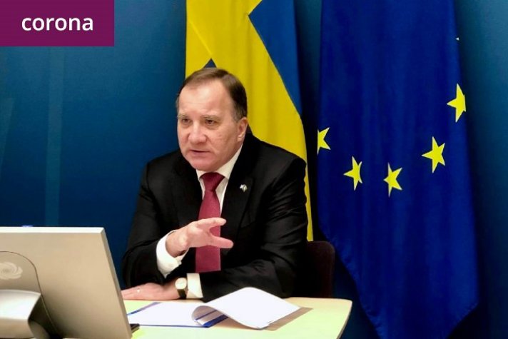 Swedish Prime Minister Stefan Löfven participating at the video conference sitting in front of a screen.