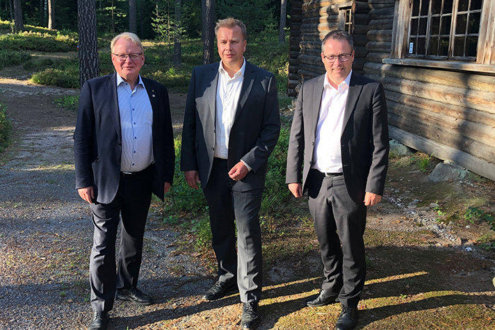 From the left: Peter Hultqvist, Antti Kaikkonen and Bjørn Arild Gram standing next to each other outside in a forrest.
