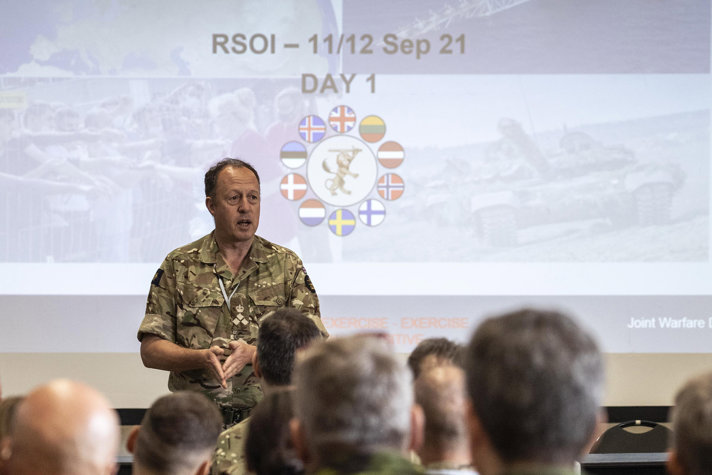 Military personnel listening to a briefing during the exercise.