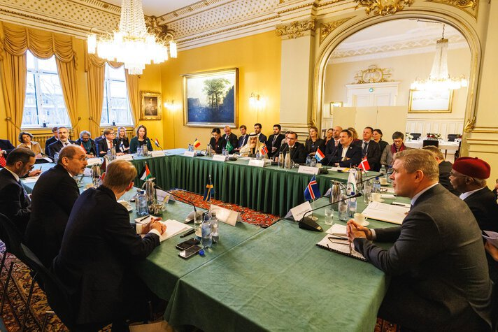 Foreign ministers from the Middle East, the Nordics and the Benelux countries sit at a meeting table in Oslo..