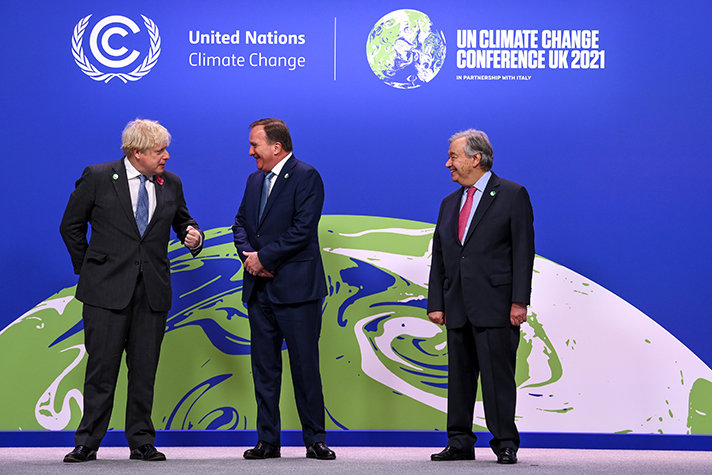Swedish Prime Minister Stefan Löfven flanked by British Prime Minister Boris Johnson and UN Secretary-General António Guterres on the podium