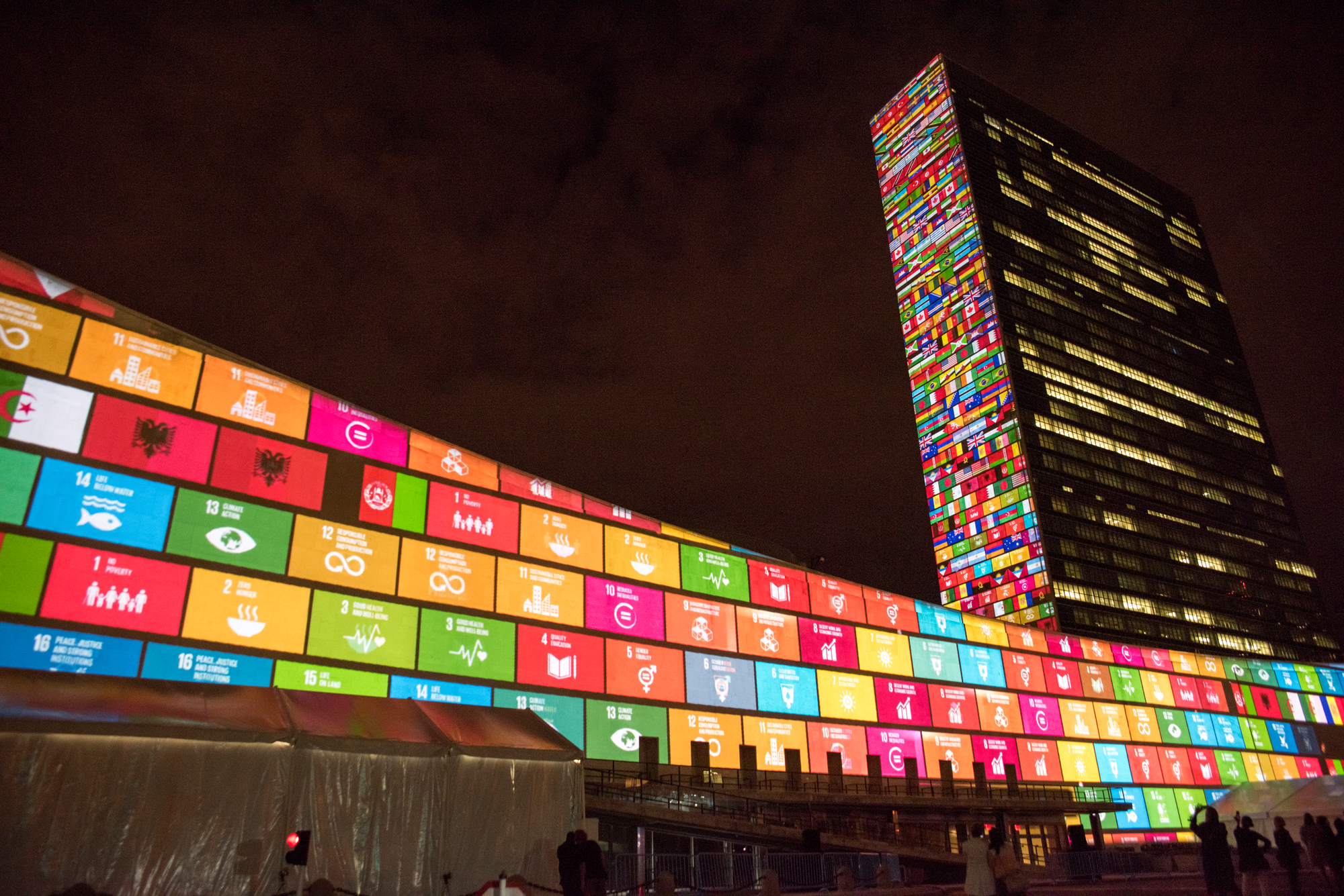 UN building lit up with UN Sustainable Development Goals. 