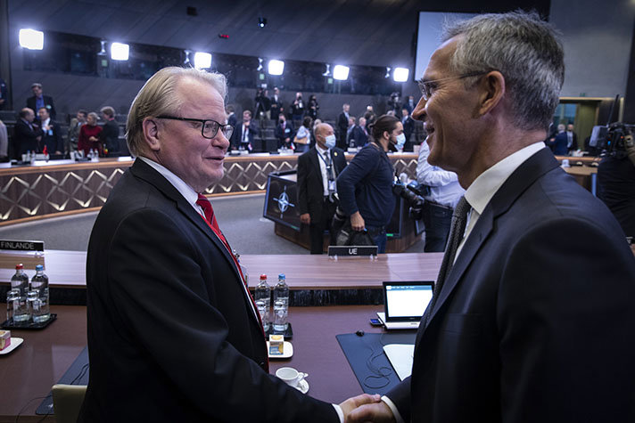 Peter Hultqvist and Jens Stoltenberg shaking hands. 
