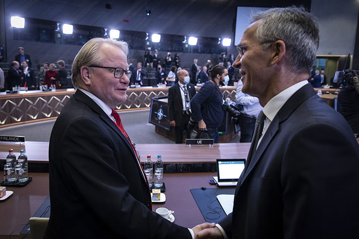 Peter Hultqvist and Jens Stoltenberg shaking hands.