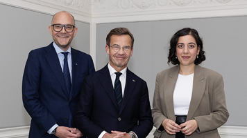 Johan Britz, Ulf Kristersson and Simona Mohamsson standing next to each other indoors.
